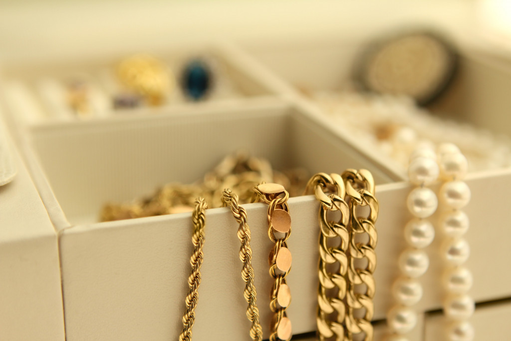 gold jewelry and pearls in box closeup of chains